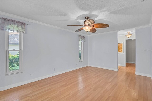 1674 Cottonwood Trl, Sarasota, FL 34232 - empty room with plenty of natural light, light wood-style flooring, ceiling fan, a textured ceiling, and ornamental molding