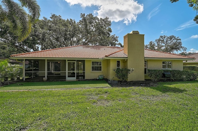 1674 Cottonwood Trl, Sarasota, FL 34232 - back of property featuring a chimney, a tiled roof, a lawn, and a sunroom