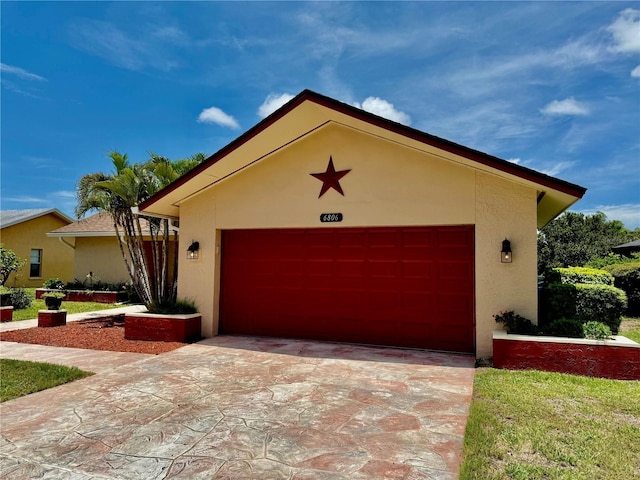 6806 18th Ave W, Bradenton, FL 34209 - view of front facade featuring stucco siding, a garage, and concrete driveway