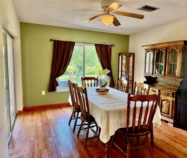 6806 18th Ave W, Bradenton, FL 34209 - dining room featuring hardwood / wood-style flooring, ceiling fan, and a textured ceiling