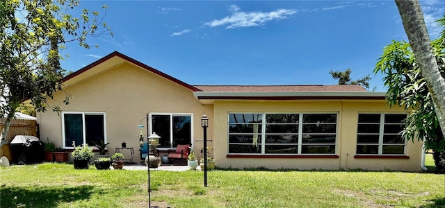 6806 18th Ave W, Bradenton, FL 34209 - back of house featuring stucco siding, a lawn, and a patio