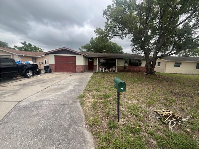 11234 Areca Dr, Port Richey, FL 34668 - single story home featuring a garage, driveway, and brick siding