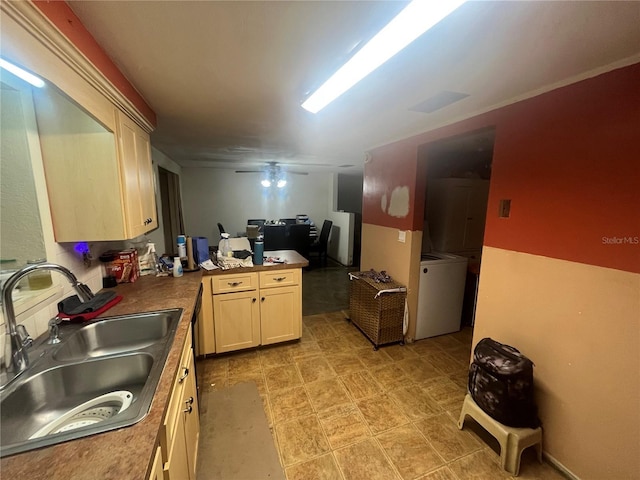 11234 Areca Dr, Port Richey, FL 34668 - kitchen featuring a peninsula, washer / dryer, a ceiling fan, and light brown cabinets