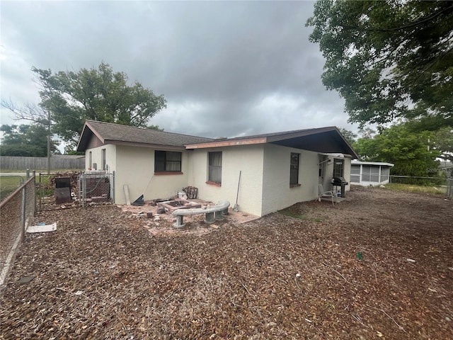 11234 Areca Dr, Port Richey, FL 34668 - rear view of property with stucco siding