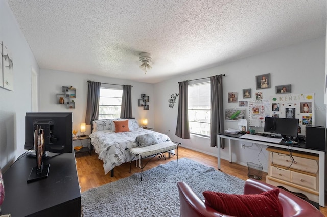 4508 101st St W Unit A, Bradenton, FL 34210 - bedroom featuring a textured ceiling, wood finished floors, and a desk
