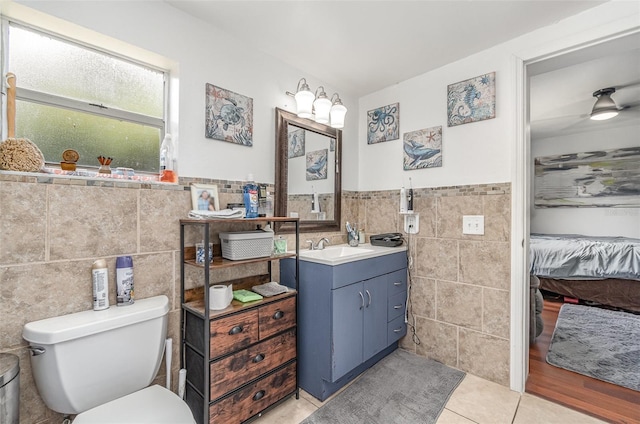 4481 Lagg Ave, Fort Myers, FL 33901 - ensuite bathroom with tile walls, vanity, tile patterned floors, and wainscoting