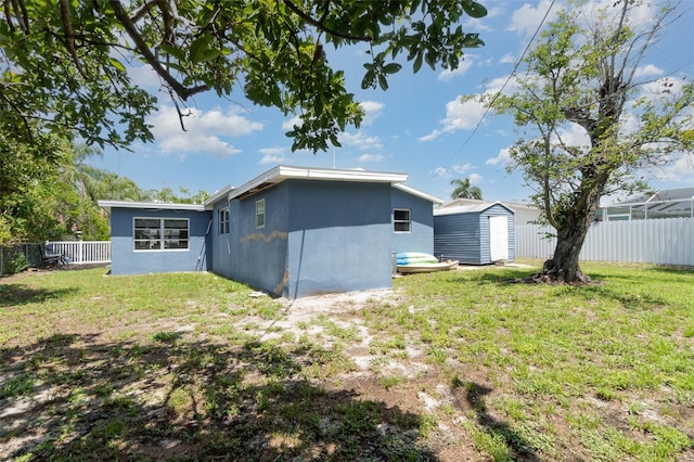 4481 Lagg Ave, Fort Myers, FL 33901 - rear view of house featuring a storage unit, a fenced backyard, and stucco siding