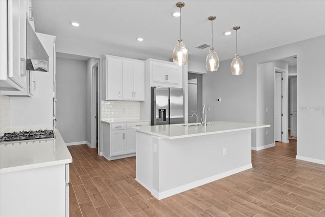 9292 Tequila Sunrise Dr, Sarasota, FL 34241 - kitchen featuring appliances with stainless steel finishes, wall chimney range hood, backsplash, light wood-style floors, and recessed lighting