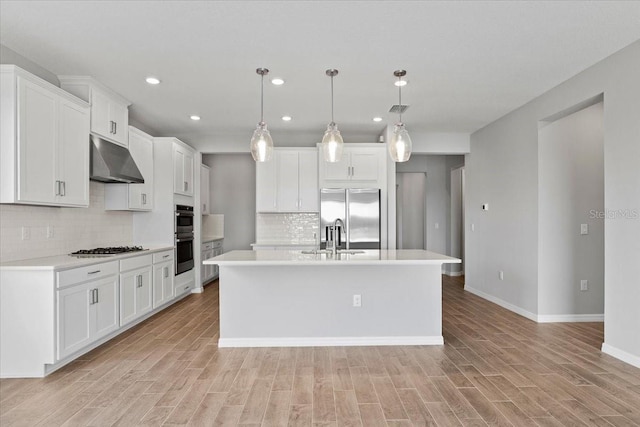 9292 Tequila Sunrise Dr, Sarasota, FL 34241 - kitchen featuring under cabinet range hood, appliances with stainless steel finishes, light countertops, tasteful backsplash, and white cabinets