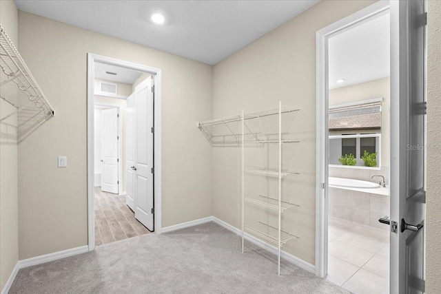 9292 Tequila Sunrise Dr, Sarasota, FL 34241 - walk in closet featuring carpet floors