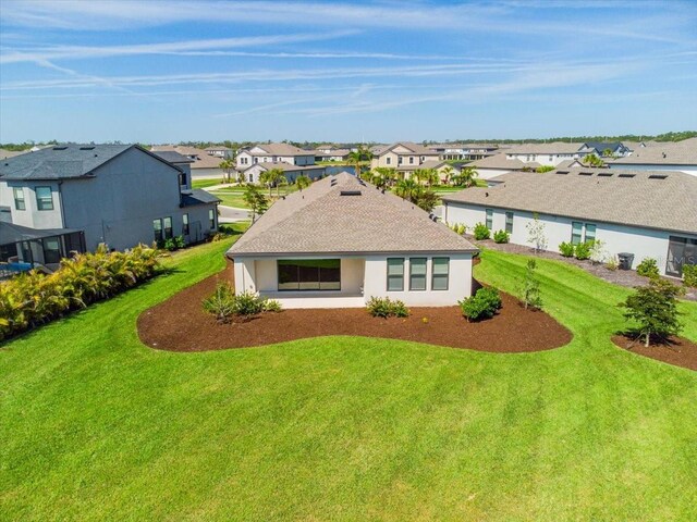 9292 Tequila Sunrise Dr, Sarasota, FL 34241 - back of property with a residential view, a yard, and stucco siding