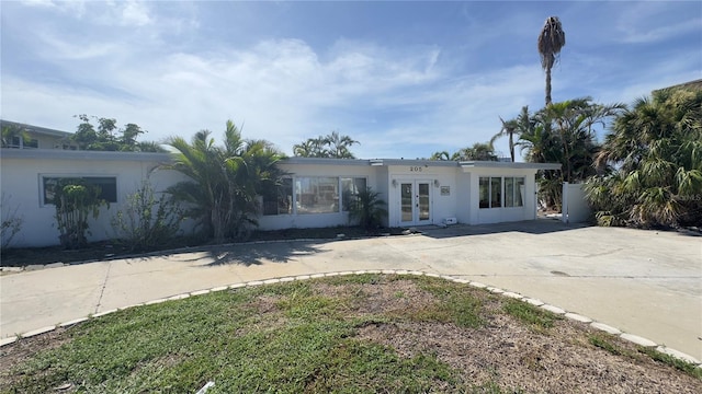 205 55th Ave, St Pete Beach, FL 33706 - back of property featuring french doors and stucco siding