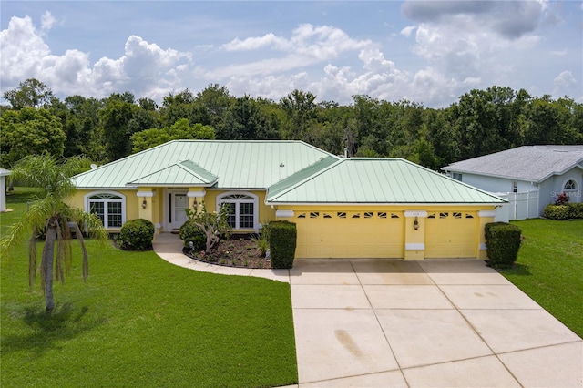 6114 68th Dr E, Palmetto, FL 34221 - ranch-style house with a standing seam roof, stucco siding, an attached garage, driveway, and a metal roof