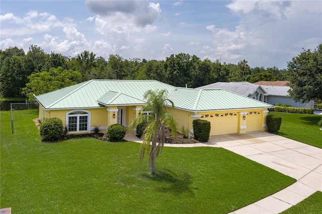 6114 68th Dr E, Palmetto, FL 34221 - single story home featuring a standing seam roof, stucco siding, an attached garage, a metal roof, and a front yard