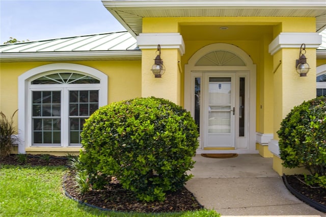 6114 68th Dr E, Palmetto, FL 34221 - doorway to property with a standing seam roof, stucco siding, and a metal roof