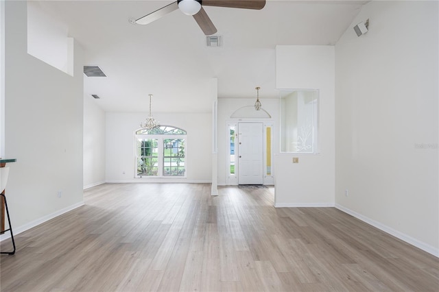 6114 68th Dr E, Palmetto, FL 34221 - unfurnished living room with a ceiling fan, light wood finished floors, and a chandelier