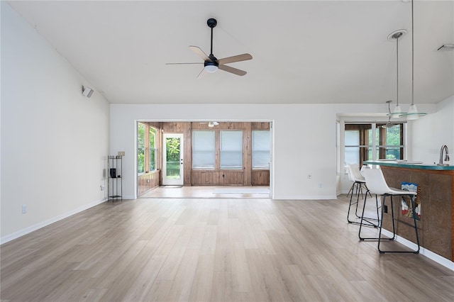 6114 68th Dr E, Palmetto, FL 34221 - unfurnished living room with ceiling fan, light wood-type flooring, and lofted ceiling