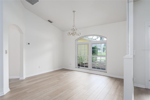 6114 68th Dr E, Palmetto, FL 34221 - unfurnished room featuring light wood finished floors, arched walkways, a chandelier, and high vaulted ceiling