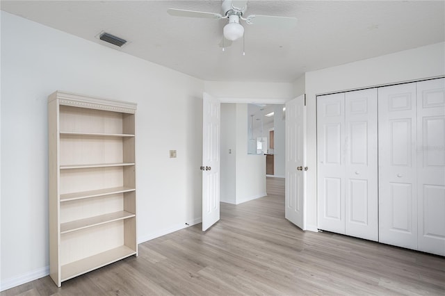 6114 68th Dr E, Palmetto, FL 34221 - unfurnished bedroom featuring light wood finished floors, a closet, and ceiling fan