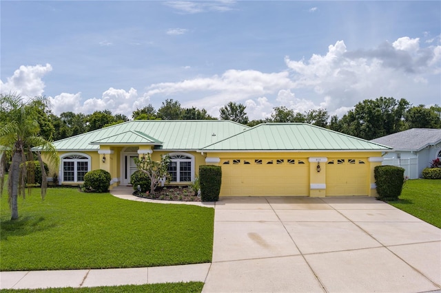 6114 68th Dr E, Palmetto, FL 34221 - single story home featuring an attached garage, a standing seam roof, driveway, stucco siding, and a front lawn