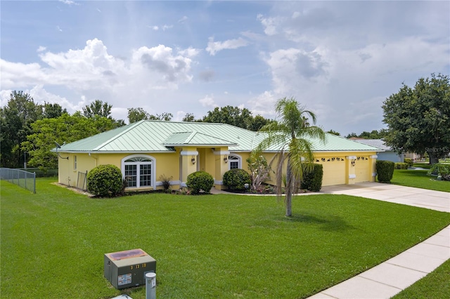 6114 68th Dr E, Palmetto, FL 34221 - ranch-style home with a standing seam roof, a metal roof, concrete driveway, a garage, and a front yard