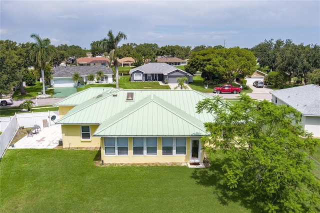 6114 68th Dr E, Palmetto, FL 34221 - rear view of house featuring stucco siding, a standing seam roof, a metal roof, a residential view, and a patio area