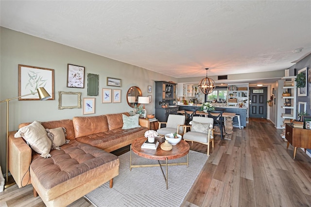 1510 1st Ave W Unit 102, Bradenton, FL 34205 - living area with a chandelier and hardwood / wood-style flooring