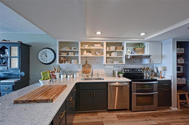 1510 1st Ave W Unit 102, Bradenton, FL 34205 - kitchen featuring stainless steel appliances, open shelves, tasteful backsplash, and recessed lighting