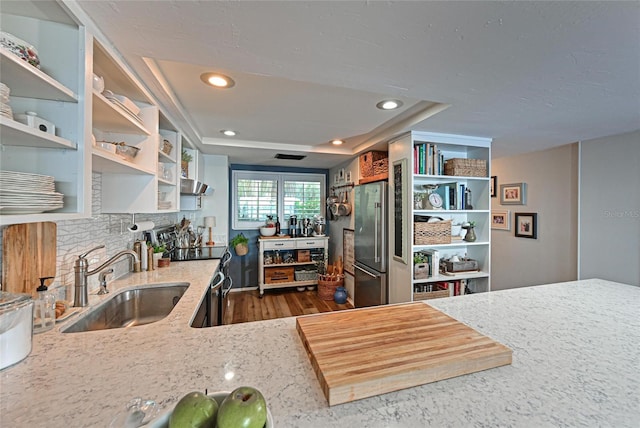 1510 1st Ave W Unit 102, Bradenton, FL 34205 - kitchen featuring range with electric stovetop, open shelves, ventilation hood, light stone counters, and high quality fridge