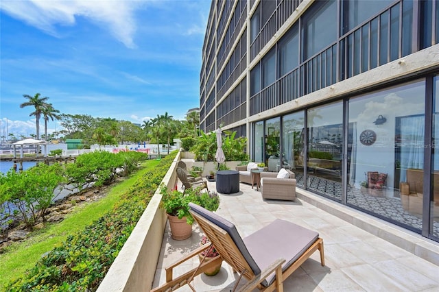 1510 1st Ave W Unit 102, Bradenton, FL 34205 - view of patio / terrace featuring an outdoor living space and a water view
