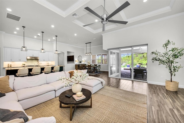 3379 Chestertown Loop, Bradenton, FL 34211 - living area with wood finished floors, ornamental molding, ceiling fan, recessed lighting, and coffered ceiling