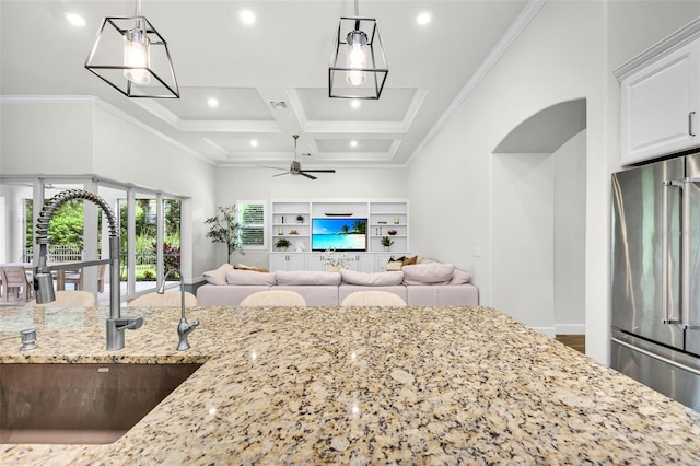 3379 Chestertown Loop, Bradenton, FL 34211 - kitchen with freestanding refrigerator, ceiling fan, light stone counters, open floor plan, and coffered ceiling