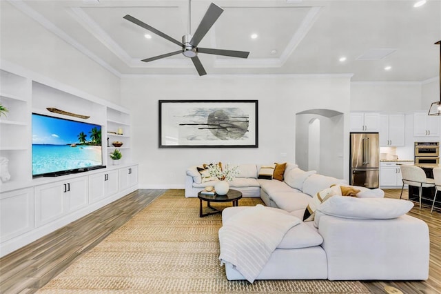3379 Chestertown Loop, Bradenton, FL 34211 - living area featuring wood finished floors, ornamental molding, arched walkways, ceiling fan, and recessed lighting