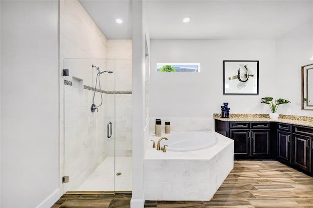 3379 Chestertown Loop, Bradenton, FL 34211 - bathroom featuring a garden tub, vanity, a stall shower, wood finished floors, and recessed lighting