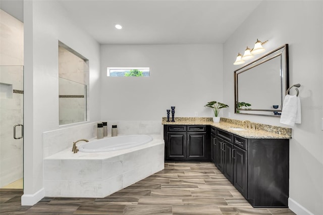 3379 Chestertown Loop, Bradenton, FL 34211 - full bath featuring a garden tub, vanity, a shower stall, wood finished floors, and recessed lighting