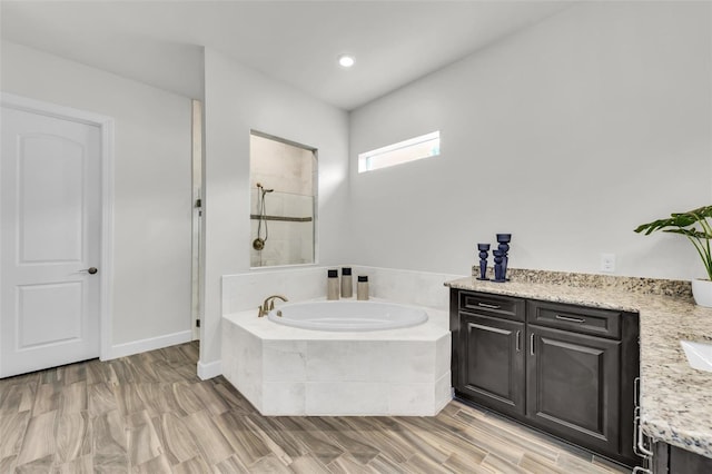 3379 Chestertown Loop, Bradenton, FL 34211 - full bathroom featuring a bath, vanity, tiled shower, and wood finished floors