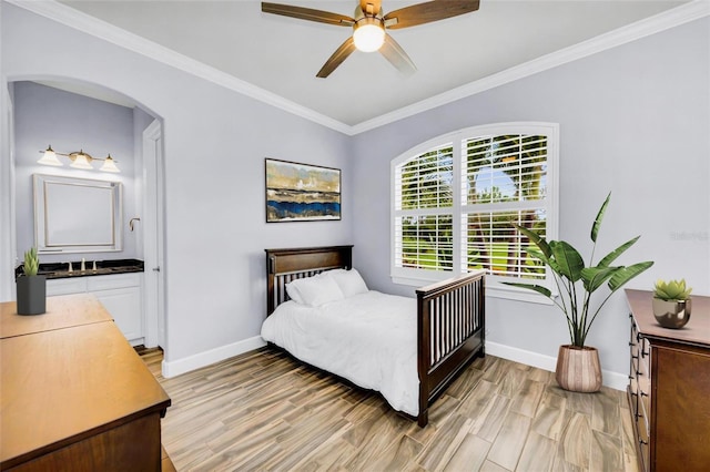 3379 Chestertown Loop, Bradenton, FL 34211 - bedroom featuring arched walkways, light wood-type flooring, crown molding, ceiling fan, and ensuite bath