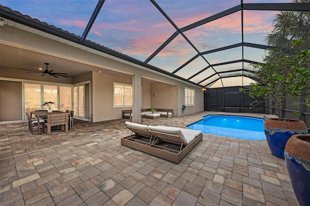 3379 Chestertown Loop, Bradenton, FL 34211 - pool at dusk with a ceiling fan, a patio area, outdoor dining area, and glass enclosure