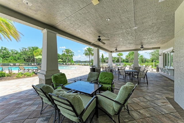 3379 Chestertown Loop, Bradenton, FL 34211 - view of patio with outdoor dining space, a ceiling fan, and a community pool