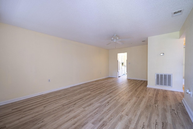 10037 62nd Ter N Unit 23, Saint Petersburg, FL 33708 - unfurnished living room featuring light wood-style flooring, a ceiling fan, and a textured ceiling