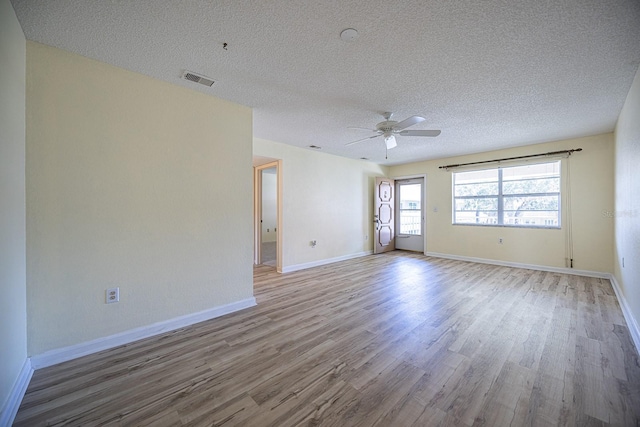 10037 62nd Ter N Unit 23, Saint Petersburg, FL 33708 - spare room featuring wood finished floors, a ceiling fan, and a textured ceiling