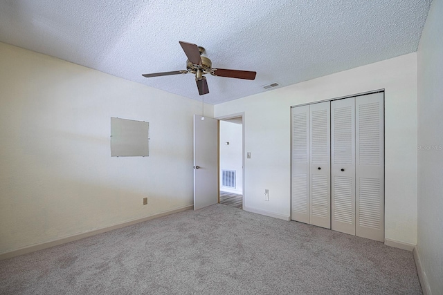 10037 62nd Ter N Unit 23, Saint Petersburg, FL 33708 - unfurnished bedroom featuring carpet flooring, a closet, a textured ceiling, and a ceiling fan