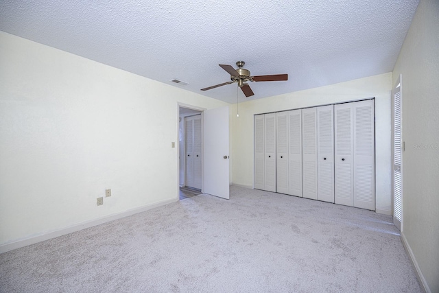 10037 62nd Ter N Unit 23, Saint Petersburg, FL 33708 - unfurnished bedroom featuring carpet flooring, ceiling fan, a textured ceiling, and a closet