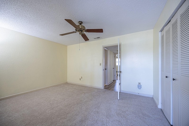 10037 62nd Ter N Unit 23, Saint Petersburg, FL 33708 - unfurnished bedroom with carpet flooring, a closet, ceiling fan, and a textured ceiling