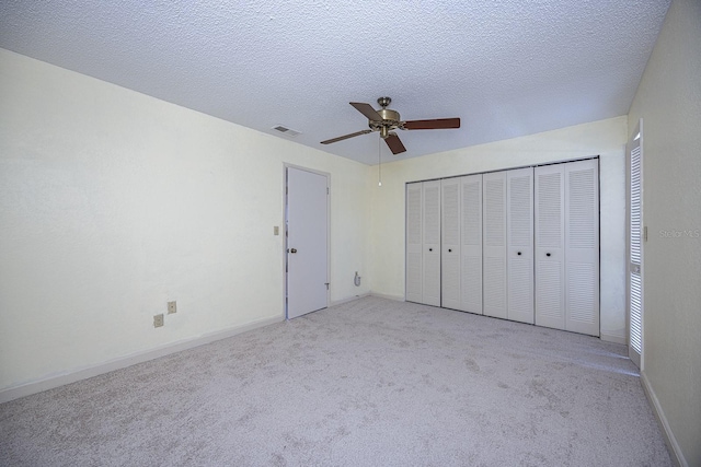 10037 62nd Ter N Unit 23, Saint Petersburg, FL 33708 - unfurnished bedroom with carpet, a ceiling fan, and a textured ceiling