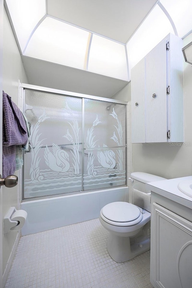 10037 62nd Ter N Unit 23, Saint Petersburg, FL 33708 - full bathroom with bath / shower combo with glass door, vanity, and tile patterned flooring