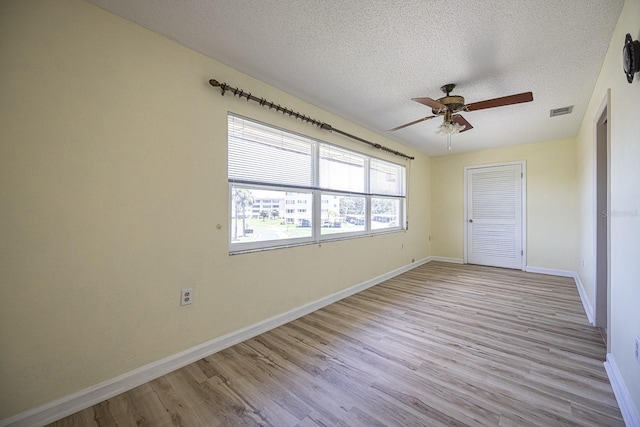10037 62nd Ter N Unit 23, Saint Petersburg, FL 33708 - unfurnished bedroom with a textured ceiling, wood finished floors, a closet, and a ceiling fan