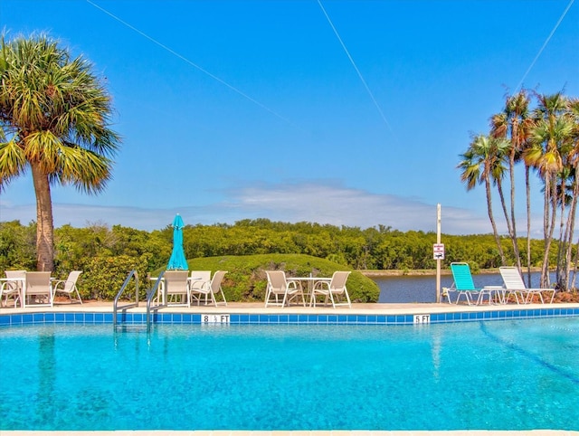 10037 62nd Ter N Unit 23, Saint Petersburg, FL 33708 - community pool featuring a patio and outdoor dining area