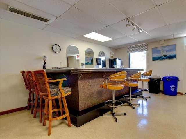 10037 62nd Ter N Unit 23, Saint Petersburg, FL 33708 - indoor dry bar with a paneled ceiling, track lighting, and refrigerator
