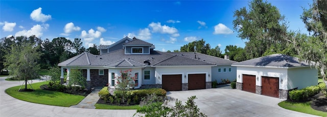 6050 Saddle Oak Trl, Sarasota, FL 34241 - view of front of house with concrete driveway, a garage, stone siding, stucco siding, and a front lawn